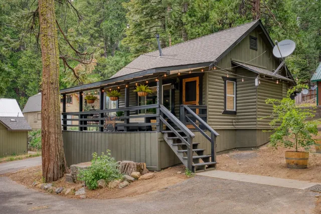 a backyard of a house with barbeque oven and table