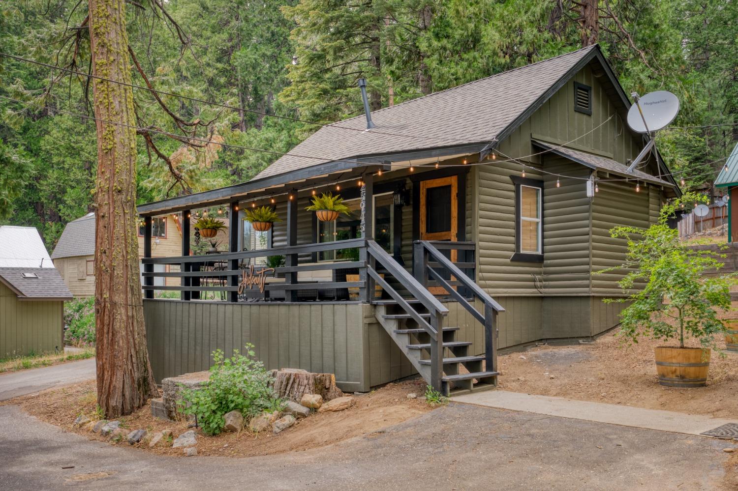 a backyard of a house with barbeque oven and table