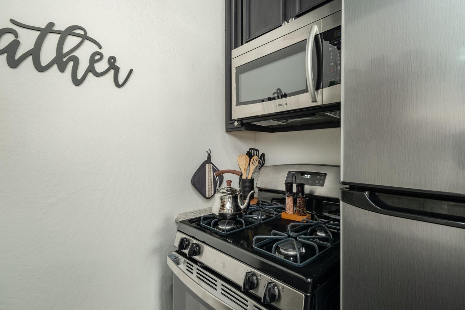 25941 Ellmaro Road Long Barn, CA 95335 - Photo 18 of 74 a kitchen with a stove and a microwave