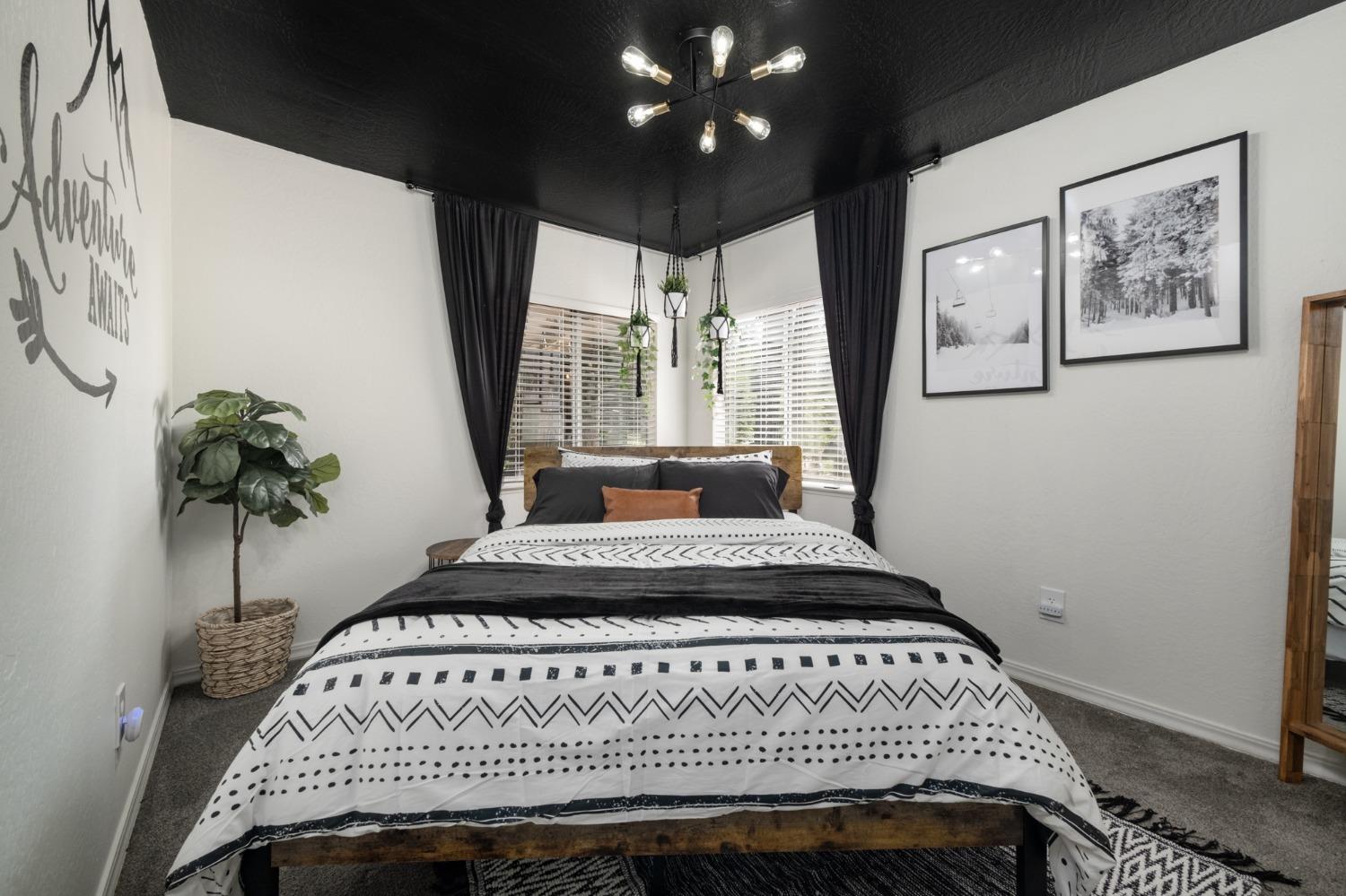 25941 Ellmaro Road Long Barn, CA 95335 - Photo 23 of 74 a bedroom with a bed and a potted plant