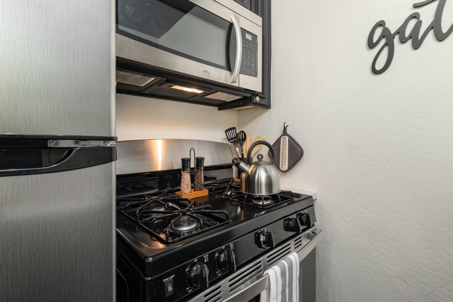 25941 Ellmaro Road Long Barn, CA 95335 - Photo 51 of 74 a stove top oven sitting inside of a kitchen