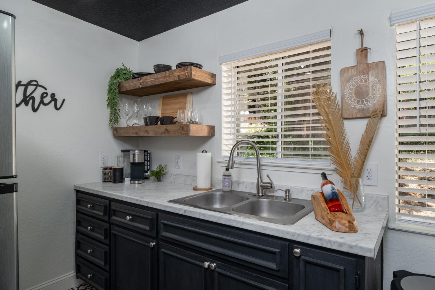 25941 Ellmaro Road Long Barn, CA 95335 - Photo 52 of 74 a kitchen with stainless steel appliances a sink and a window