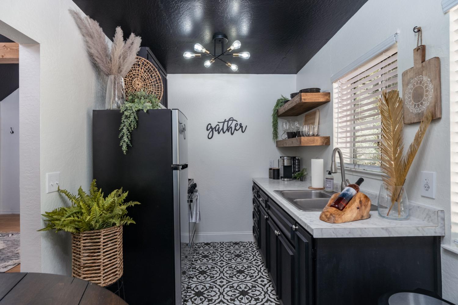 25941 Ellmaro Road Long Barn, CA 95335 - Photo 54 of 74 a kitchen with stainless steel appliances granite countertop a sink a stove a refrigerator and a potted plant