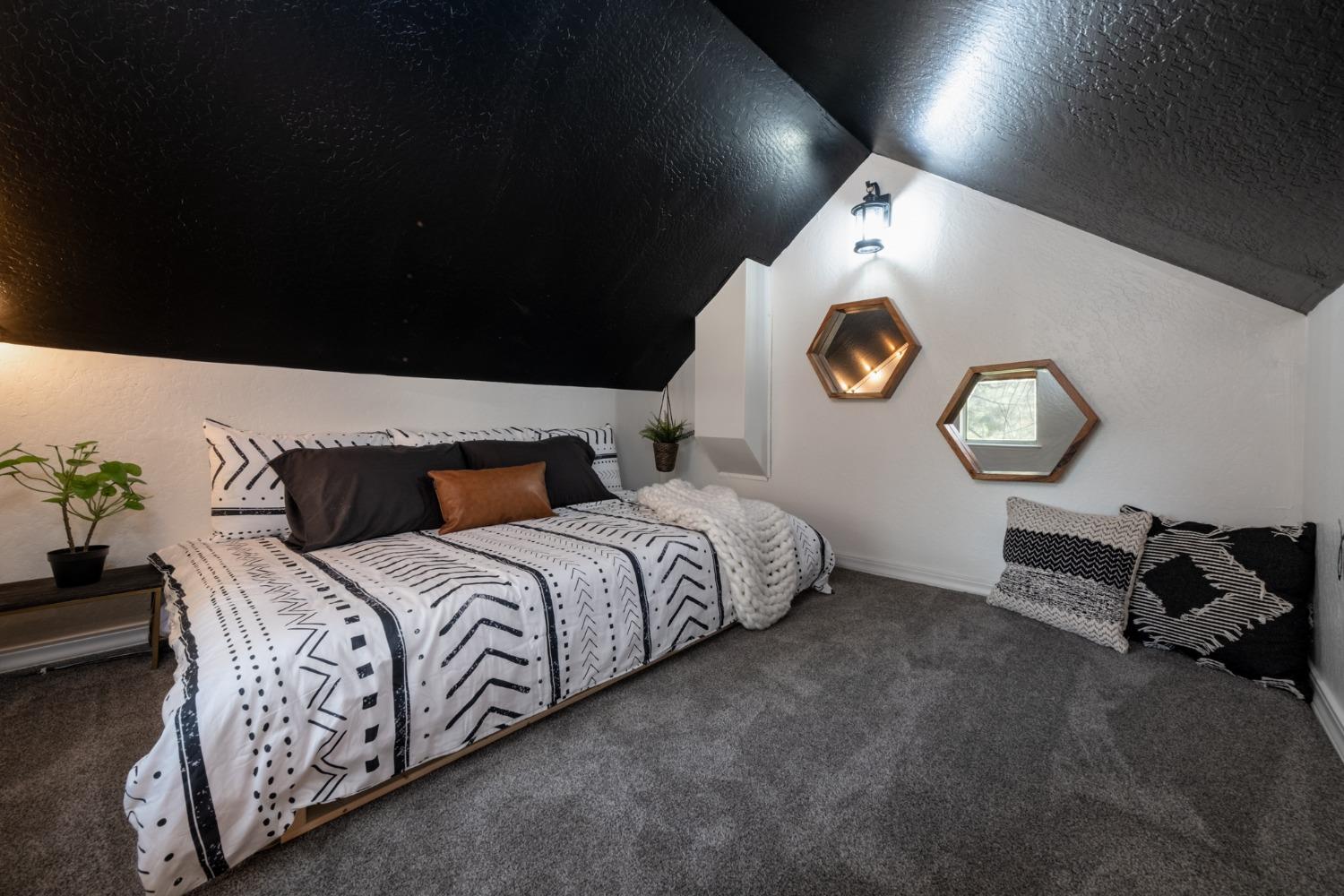 25941 Ellmaro Road Long Barn, CA 95335 - Photo 59 of 74 a spacious bedroom with a bed and a lamp on table