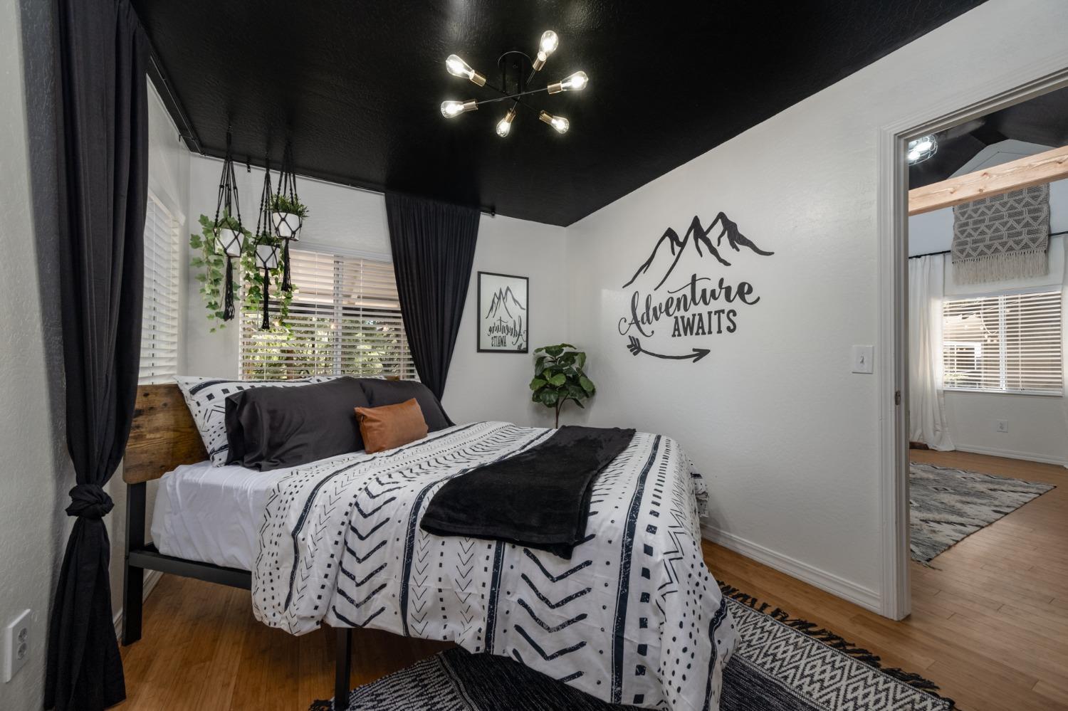 25941 Ellmaro Road Long Barn, CA 95335 - Photo 61 of 74 a bedroom with a bed and wooden floor