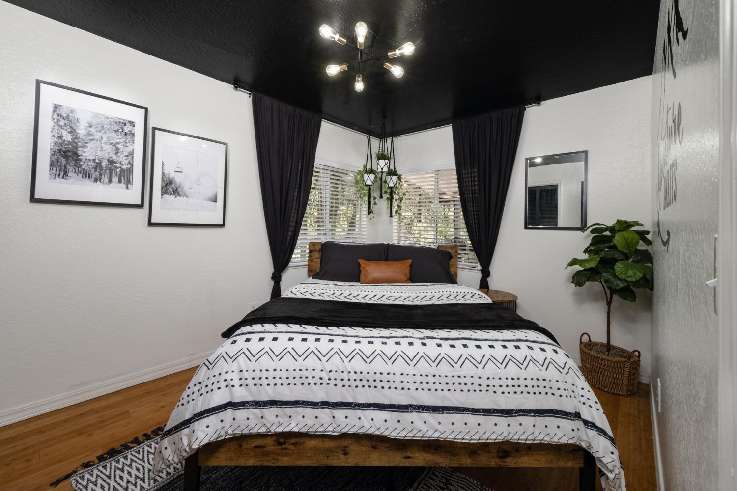 25941 Ellmaro Road Long Barn, CA 95335 - Photo 62 of 74 a bedroom with a bed and a potted plant