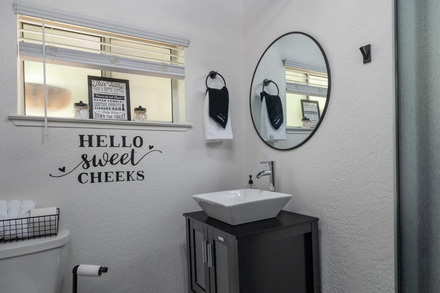 25941 Ellmaro Road Long Barn, CA 95335 - Photo 65 of 74 a bathroom with a toilet sink and mirror