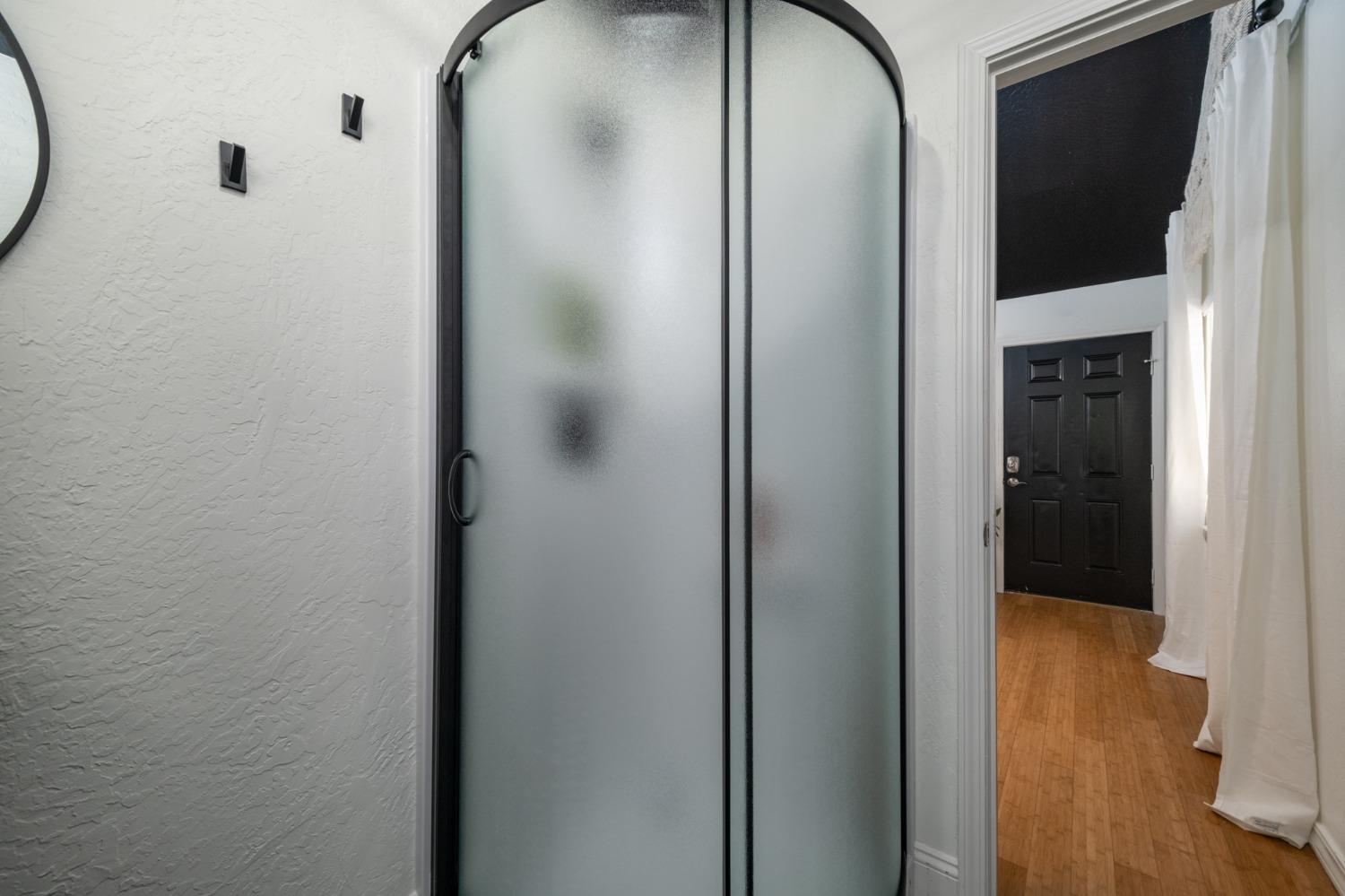 25941 Ellmaro Road Long Barn, CA 95335 - Photo 67 of 74 a bathroom with a glass shower door and a mirror
