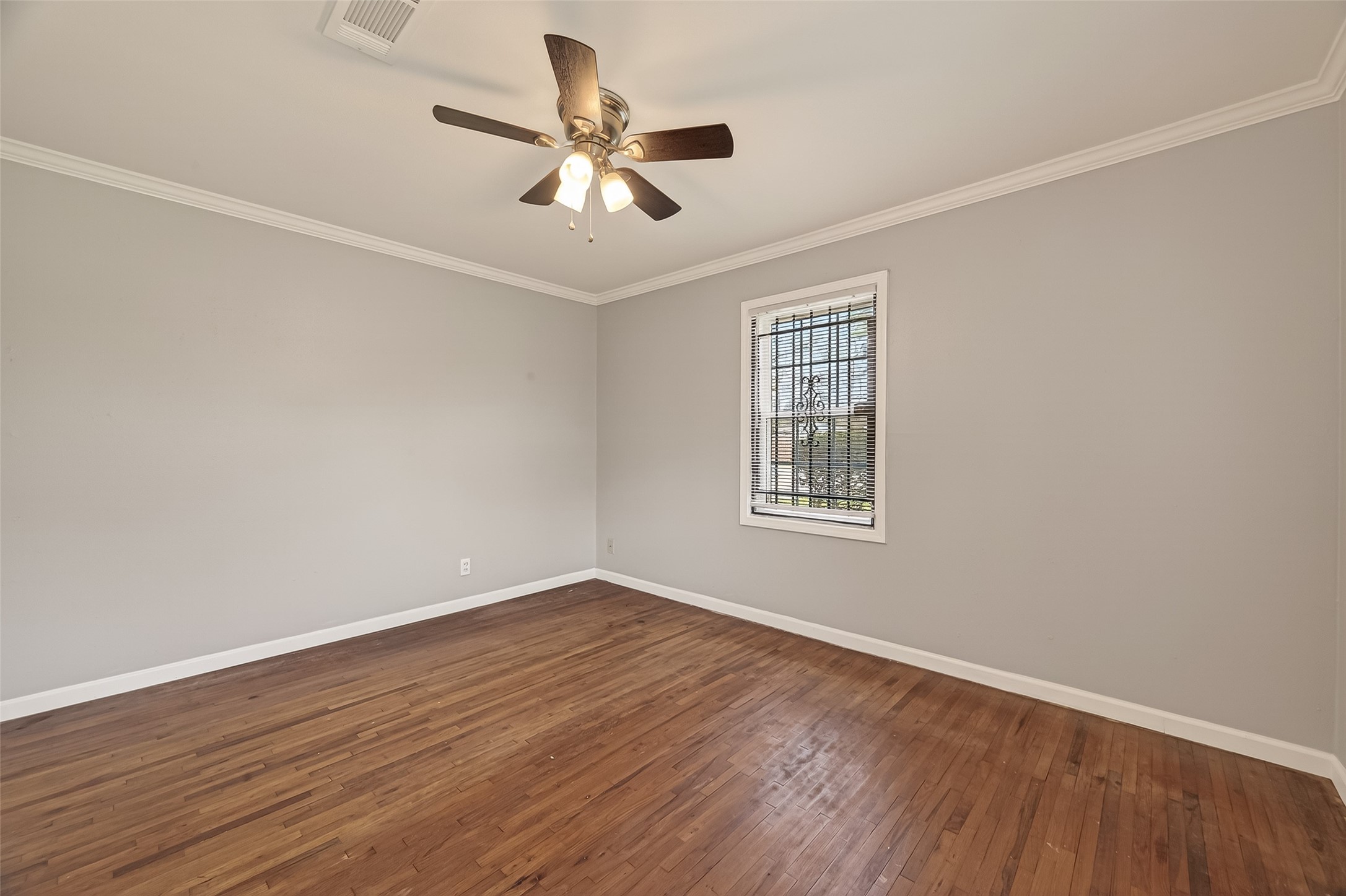 2619 Homer Street Houston, TX 77091 - Photo 12 of 23 wooden floor in an empty room with a window