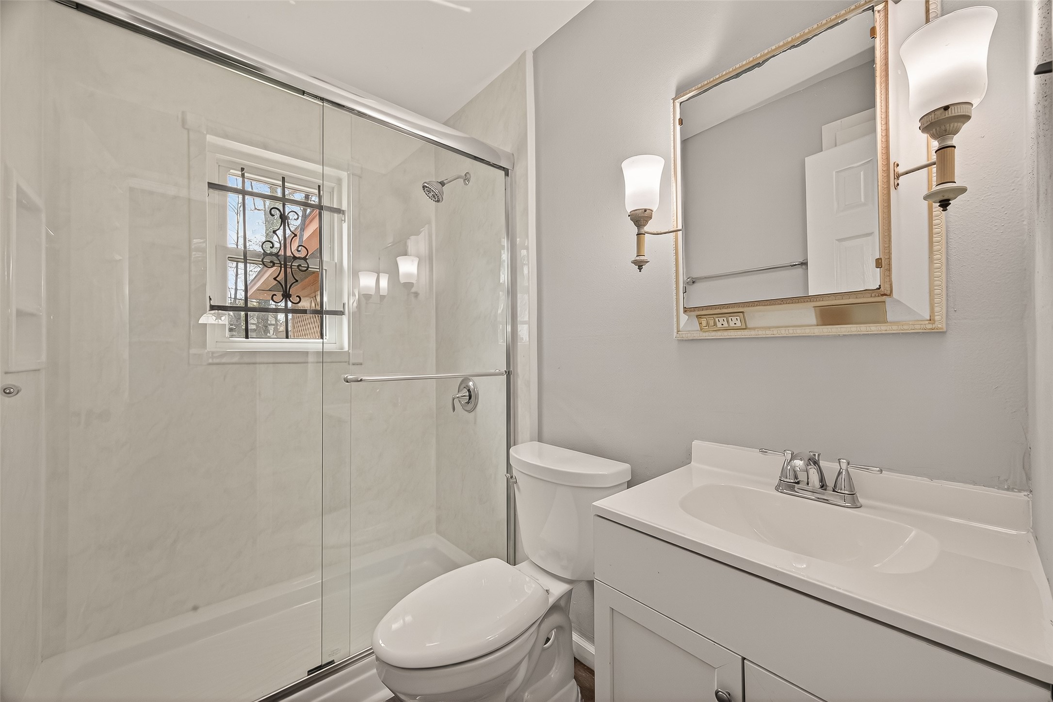 2619 Homer Street Houston, TX 77091 - Photo 13 of 23 a white toilet sitting next to a bathroom sink