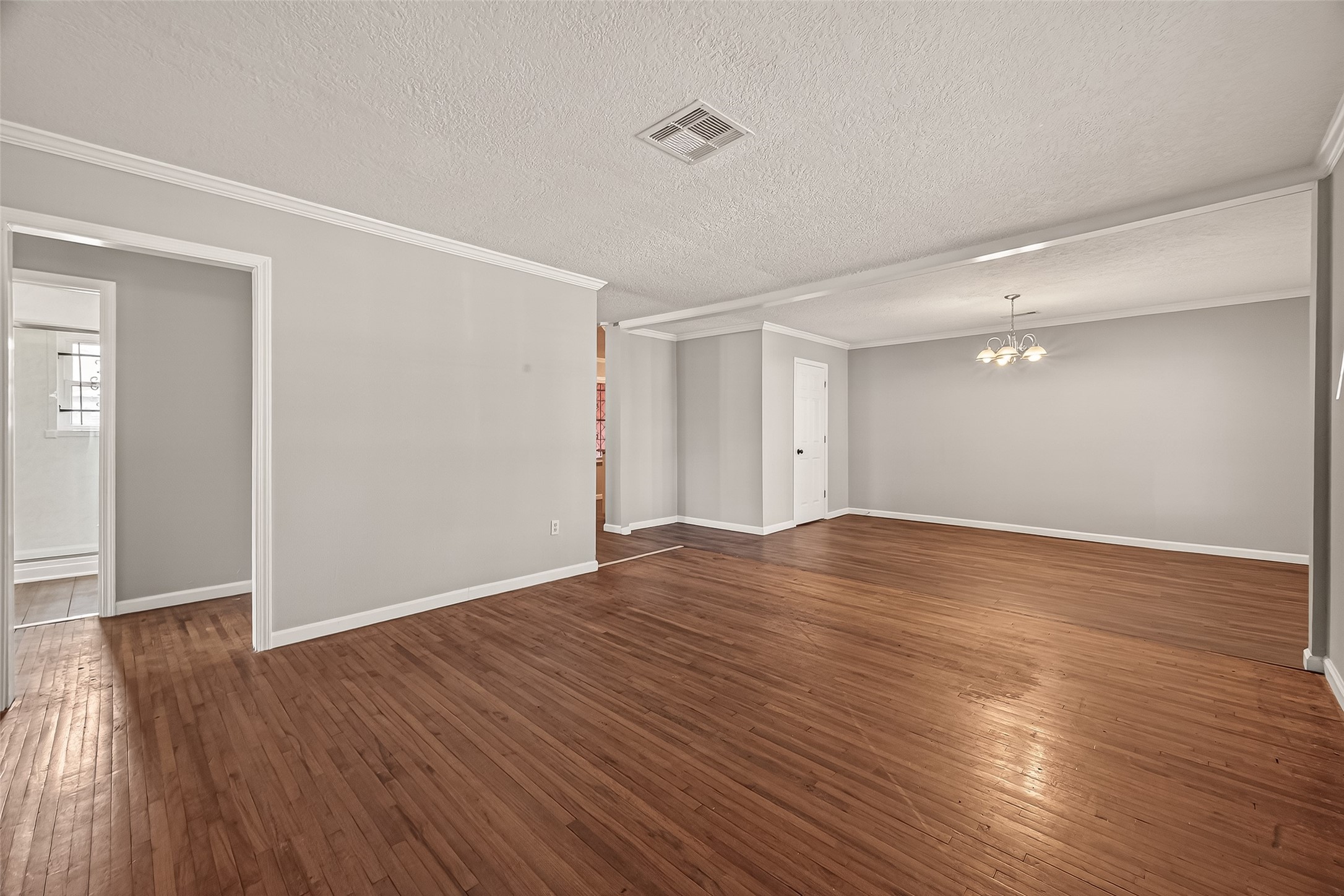 2619 Homer Street Houston, TX 77091 - Photo 3 of 23 a view of empty room with wooden floor and fan