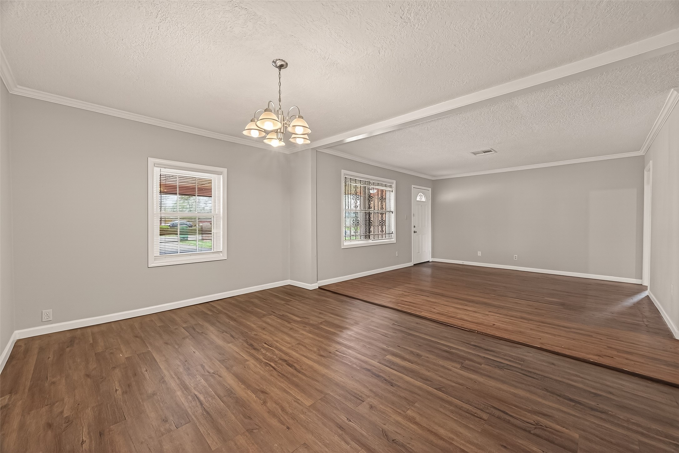 2619 Homer Street Houston, TX 77091 - Photo 5 of 23 a view of an empty room with wooden floor and a window