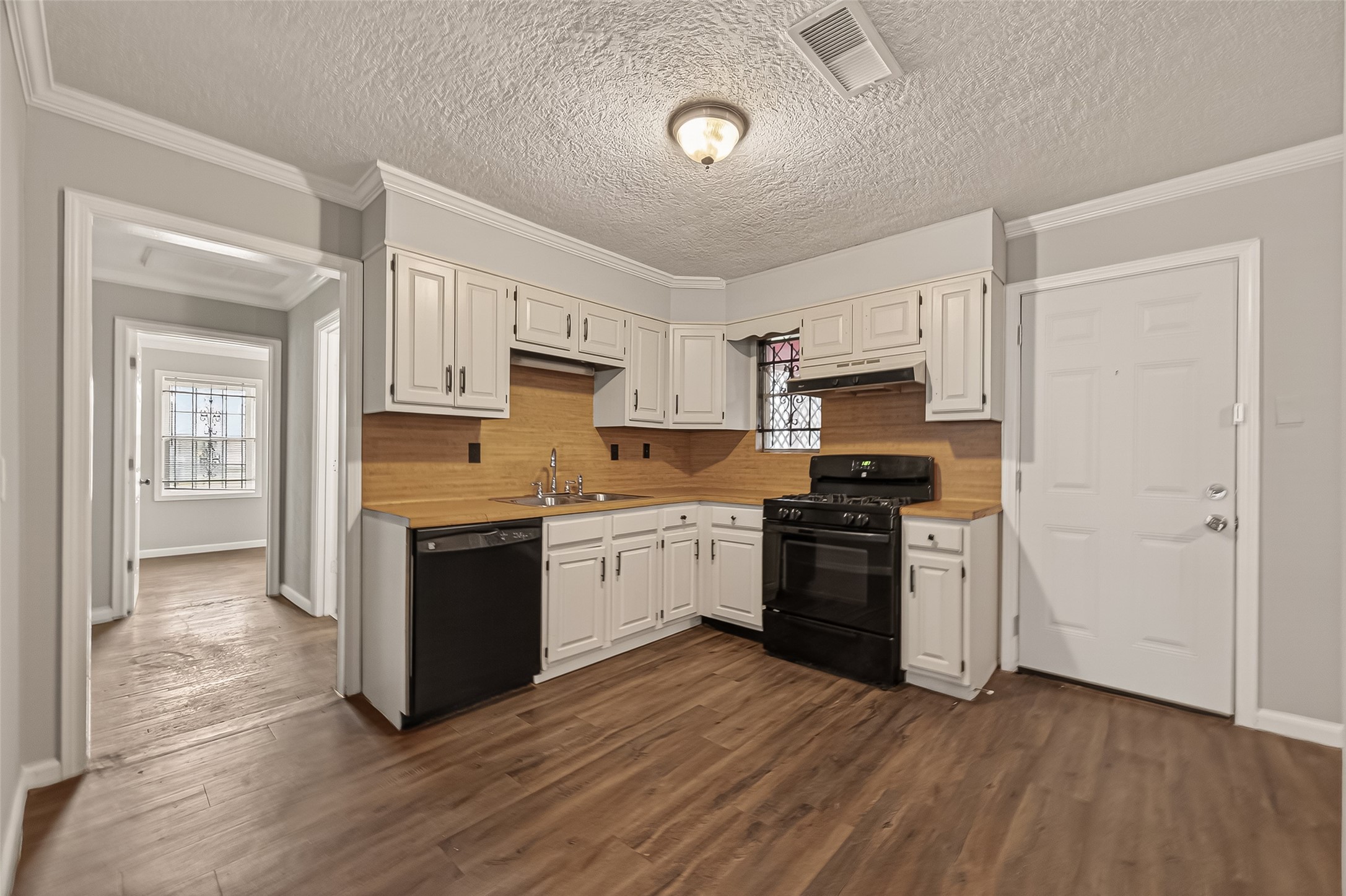 2619 Homer Street Houston, TX 77091 - Photo 6 of 23 a kitchen with granite countertop a refrigerator stove top oven and sink