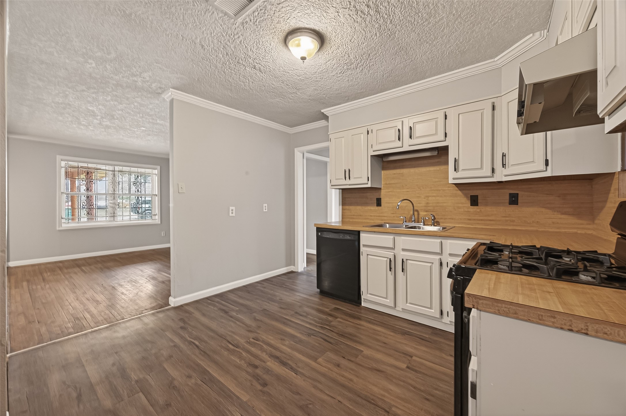 2619 Homer Street Houston, TX 77091 - Photo 7 of 23 a kitchen with granite countertop a stove top oven sink and cabinets