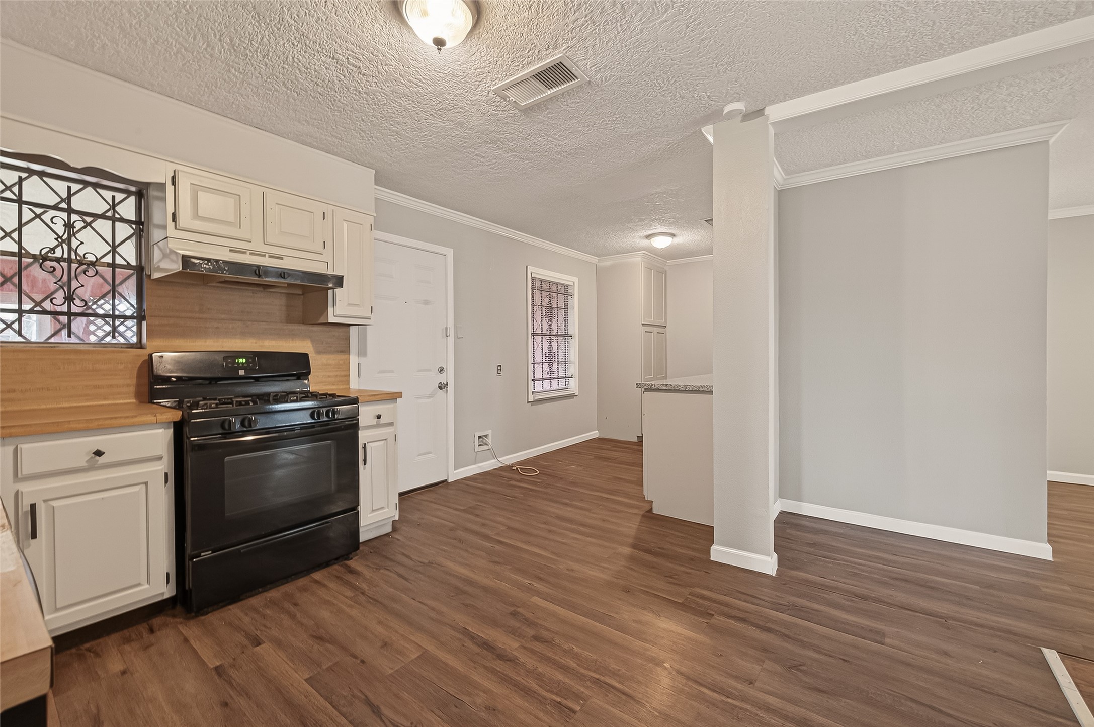 2619 Homer Street Houston, TX 77091 - Photo 8 of 23 a kitchen with granite countertop a refrigerator and a stove top oven
