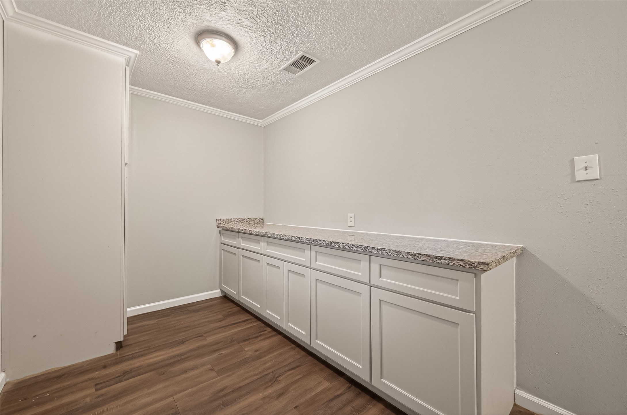 2619 Homer Street Houston, TX 77091 - Photo 9 of 23 a view of storage and utility room with wooden floor