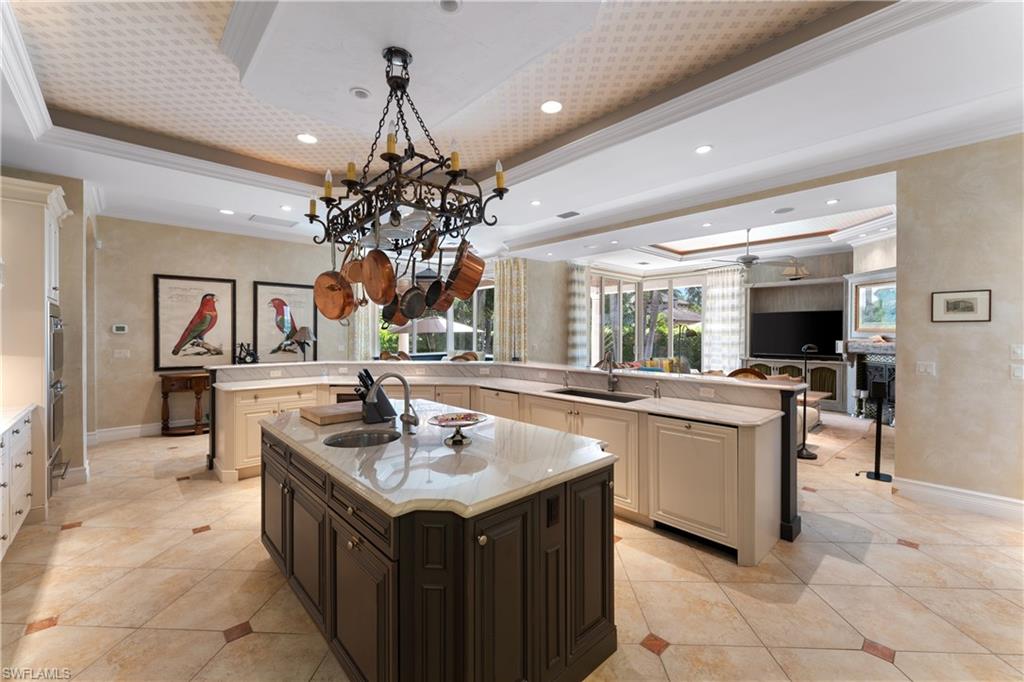 590 17th Avenue South Naples, FL 34102 - Photo 12 of 50 a kitchen with a sink and cabinets