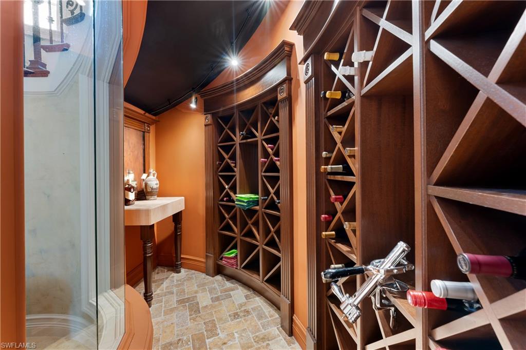 590 17th Avenue South Naples, FL 34102 - Photo 18 of 50 a view of walk in closet with clothes and shoes
