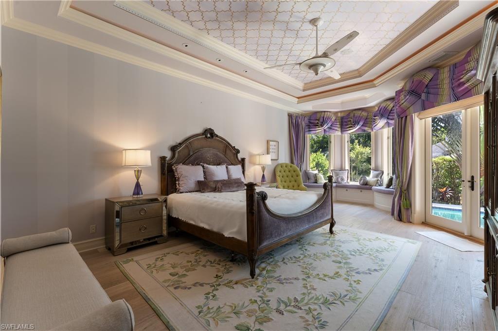 590 17th Avenue South Naples, FL 34102 - Photo 21 of 50 a bedroom with a bed mirror and window