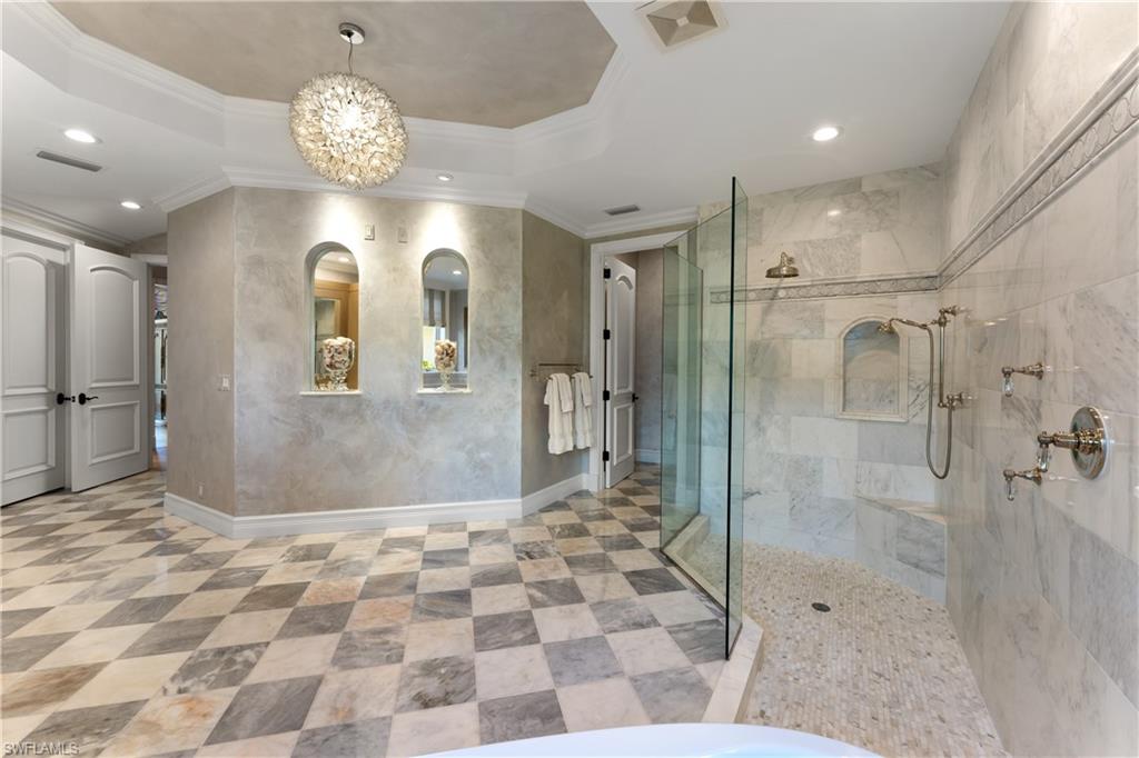 590 17th Avenue South Naples, FL 34102 - Photo 24 of 50 a view of a hallway with wooden floor and a chandelier