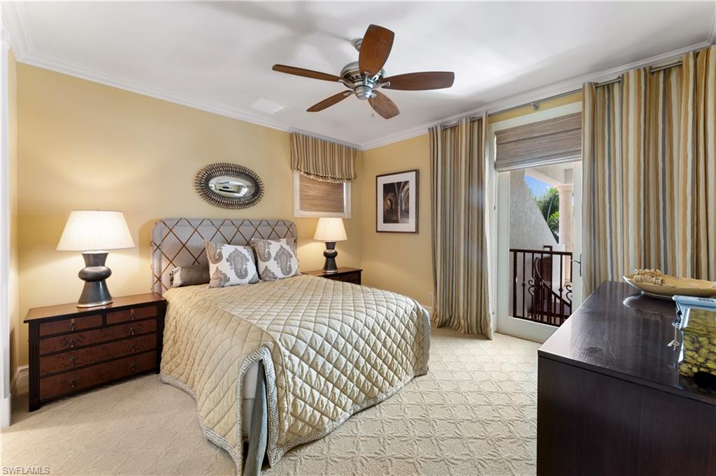 590 17th Avenue South Naples, FL 34102 - Photo 28 of 50 a bedroom with a bed and a chandelier