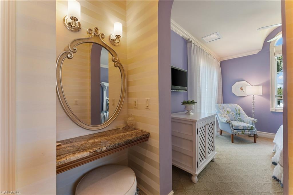 590 17th Avenue South Naples, FL 34102 - Photo 30 of 50 a living room with furniture and a mirror