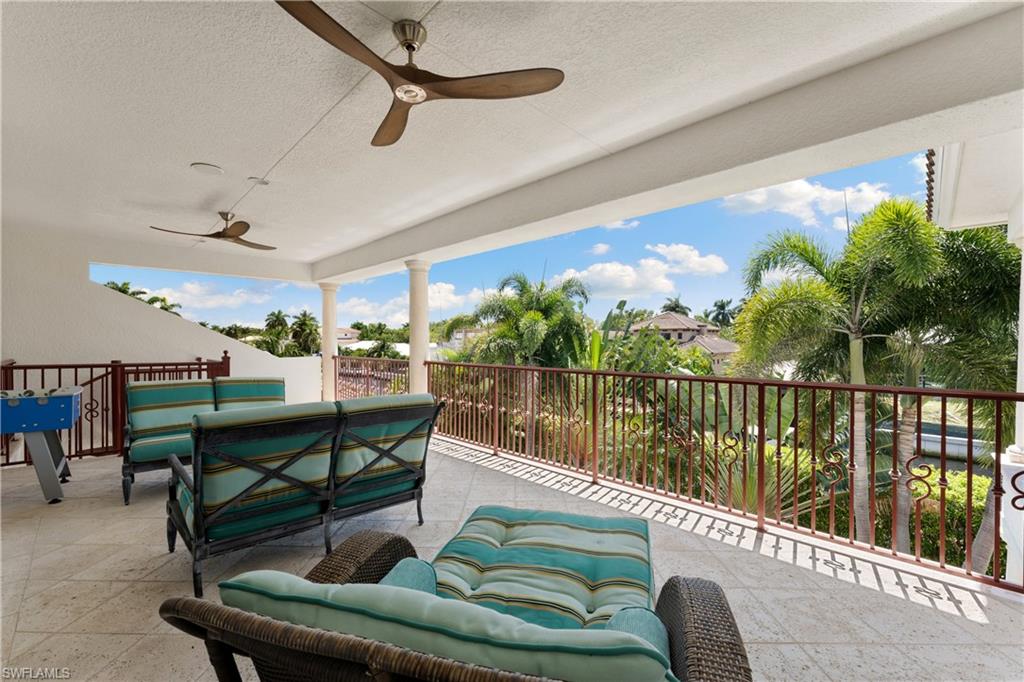 590 17th Avenue South Naples, FL 34102 - Photo 35 of 50 a balcony with furniture and a potted plant