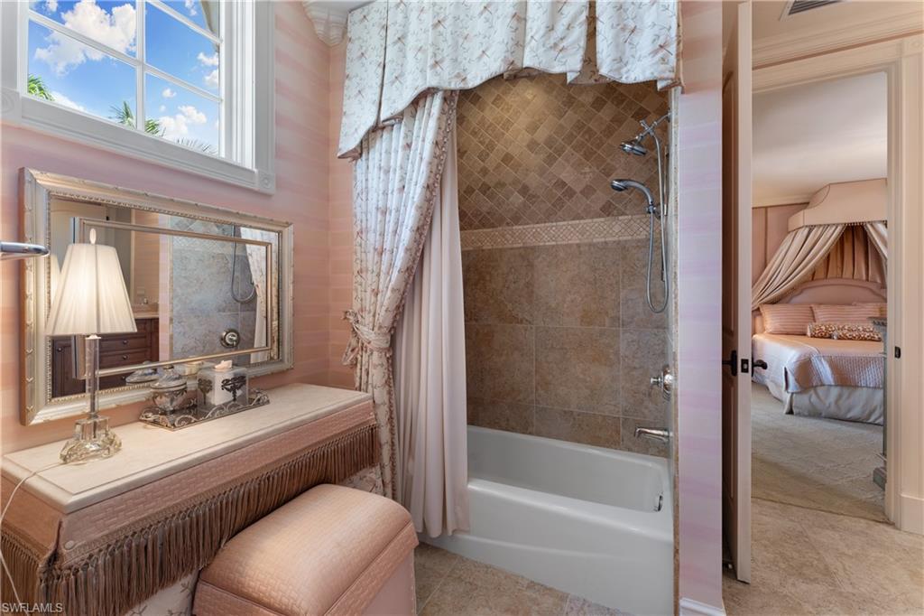 590 17th Avenue South Naples, FL 34102 - Photo 38 of 50 a bathroom with a sink a toilet and shower