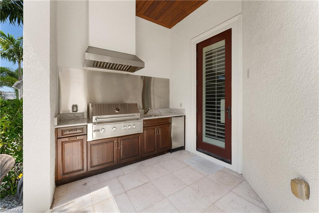 590 17th Avenue South Naples, FL 34102 - Photo 45 of 50 a kitchen with a stove and a refrigerator