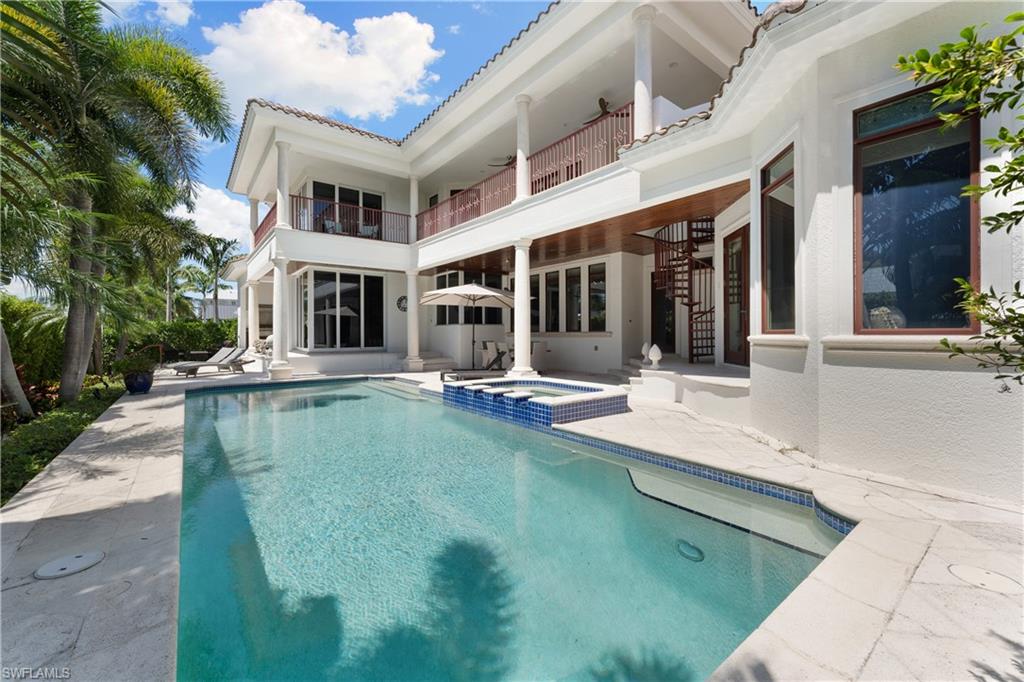 590 17th Avenue South Naples, FL 34102 - Photo 47 of 50 a view of a building with a large window and potted plants