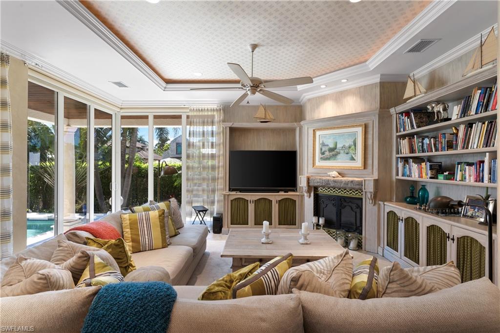 590 17th Avenue South Naples, FL 34102 - Photo 7 of 50 a living room with furniture or fireplace and a flat screen tv