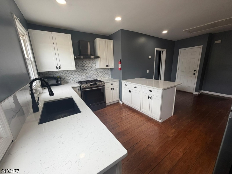 166 Renner Avenue, Unit 3 Newark, NJ 07112 - Photo 6 of 24 a kitchen with a sink a stove a refrigerator and cabinets