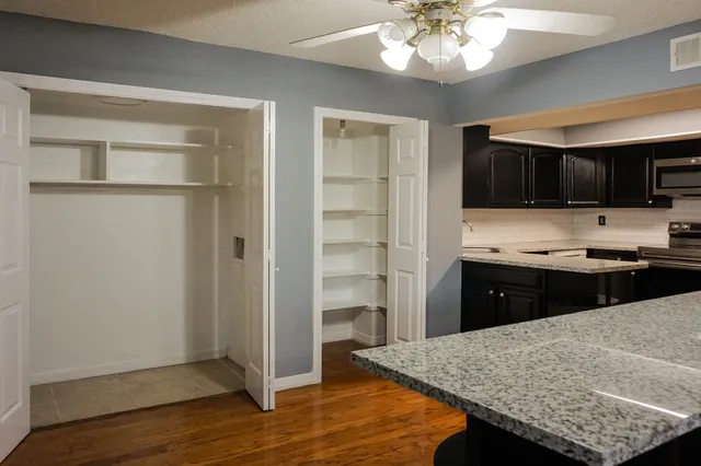 a kitchen with stainless steel appliances granite countertop a refrigerator and a stove top oven