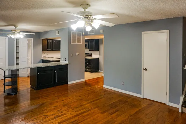 a living room with stainless steel appliances kitchen island granite countertop furniture and a kitchen view