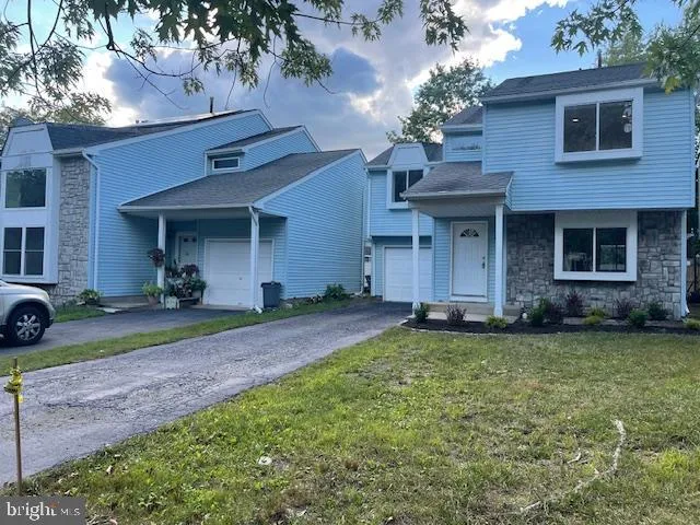 a view of a house with a yard and plants