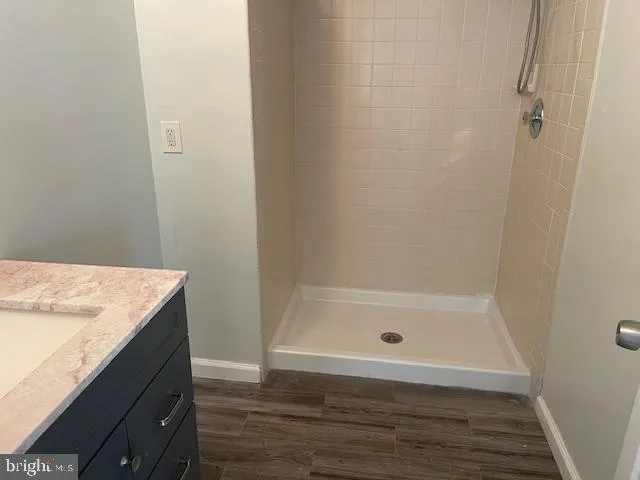 a bathroom with a shower and a sink