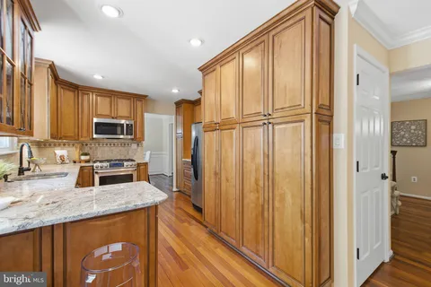 a kitchen with a sink stove and refrigerator