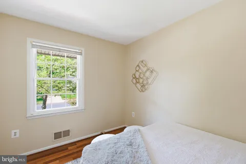 a bedroom with a bed and a night stand