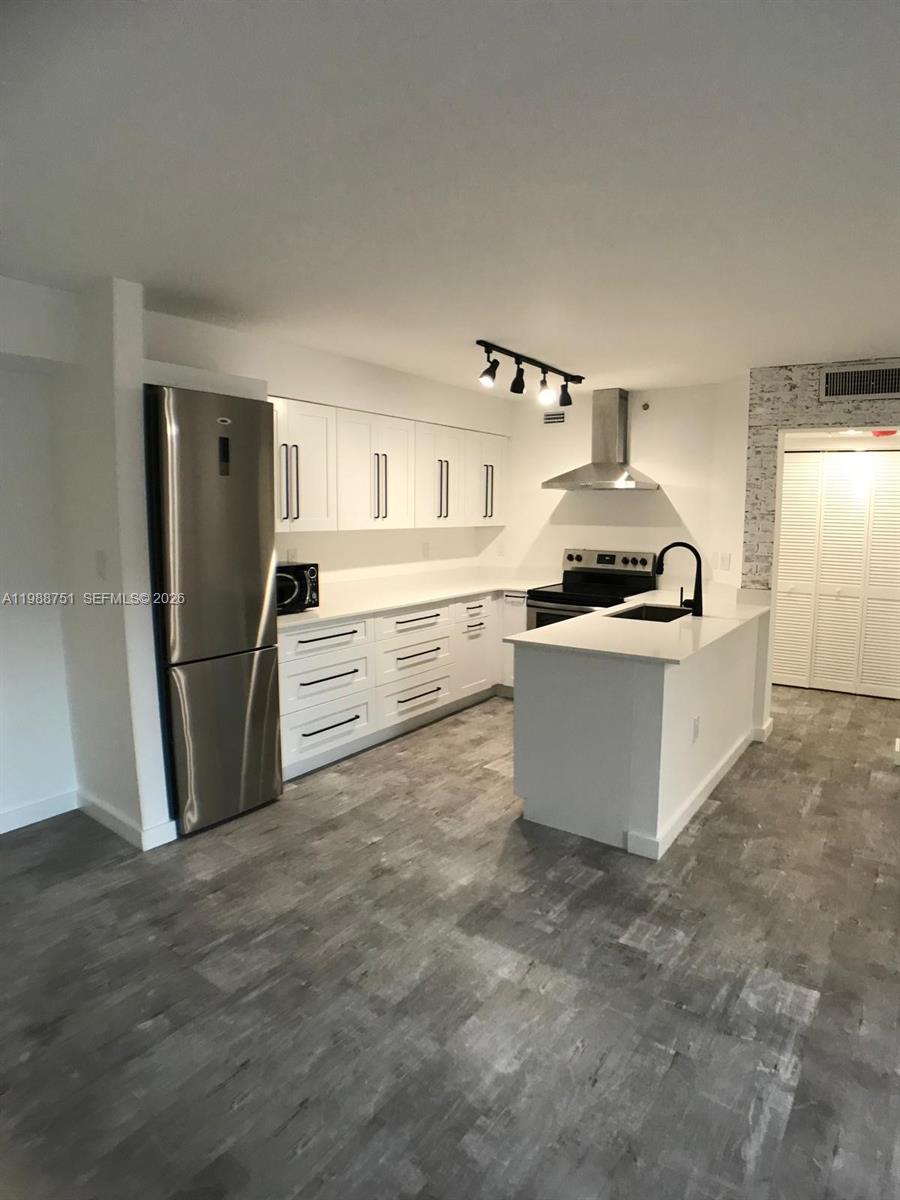 751 North Pine Island Road, Unit 211 Plantation, FL 33324 - Photo 3 of 3 a kitchen with stainless steel appliances granite countertop a refrigerator a stove a sink and a refrigerator