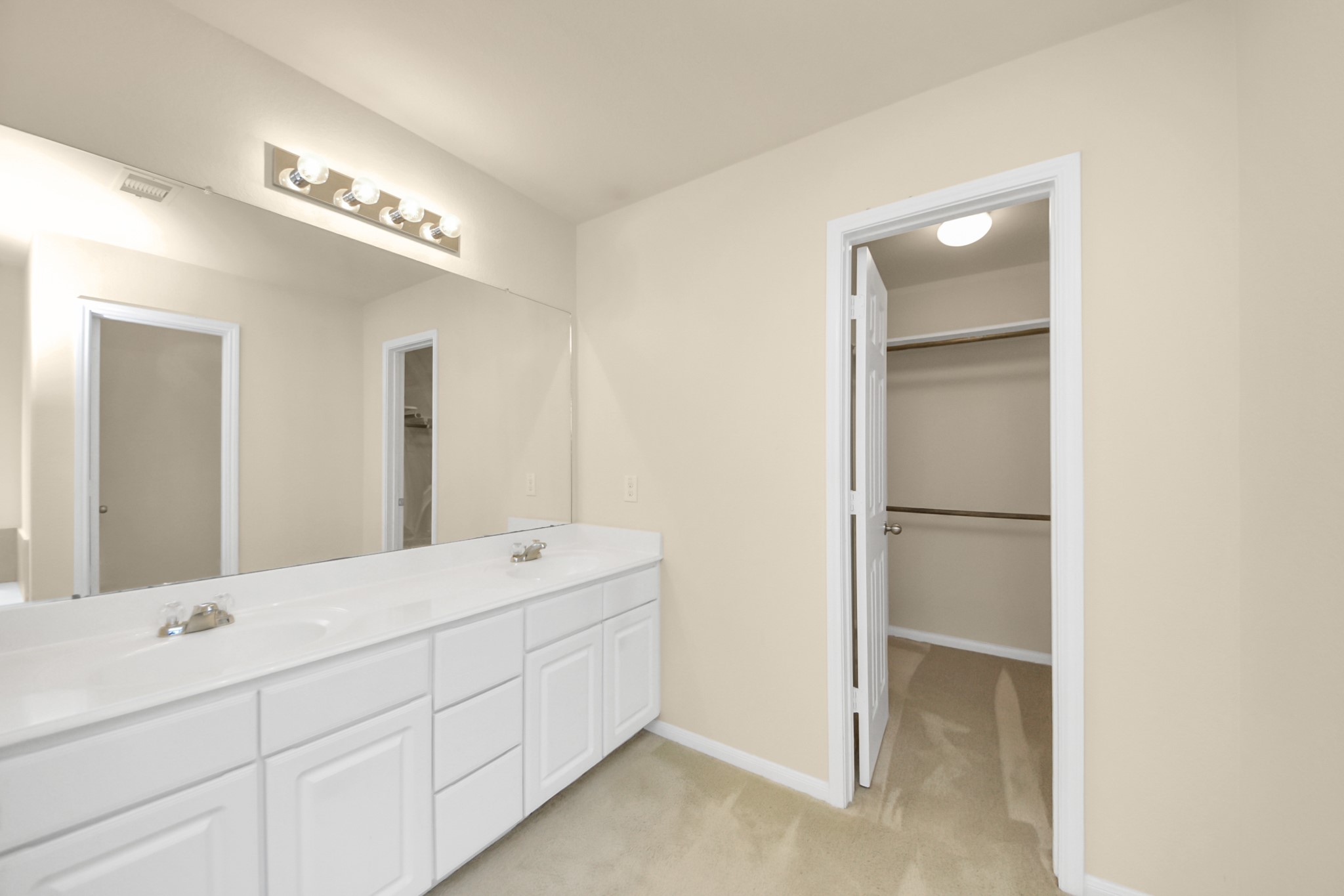 15623 Sheldon Ridge Way Houston, TX 77044 - Photo 14 of 36 a en suite bathroom with a double vanity sink and a mirror