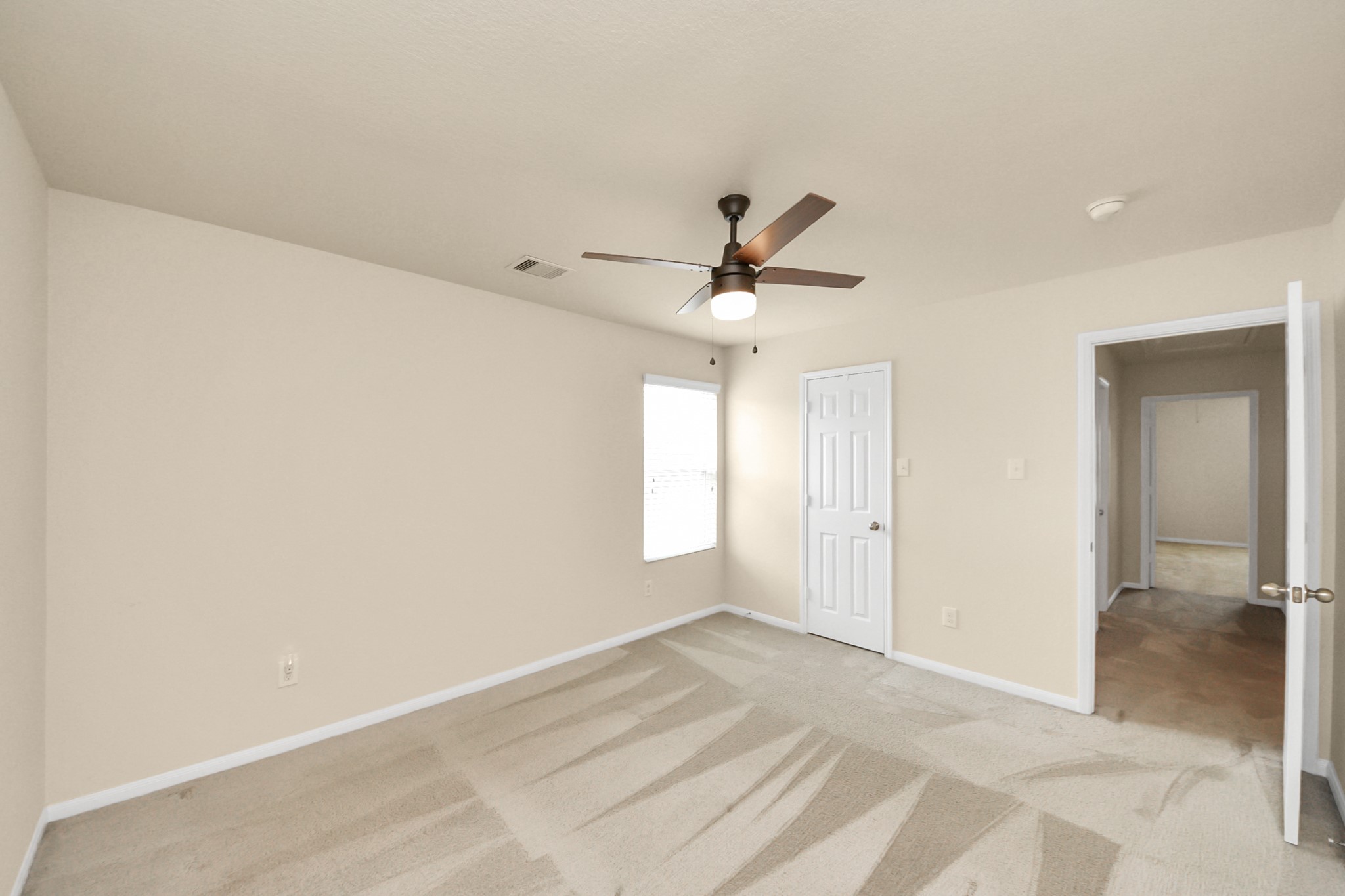 15623 Sheldon Ridge Way Houston, TX 77044 - Photo 31 of 36 an empty room with a ceiling fan and wooden floor