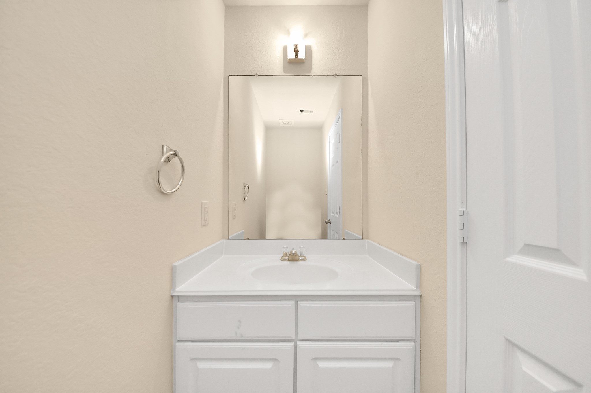 15623 Sheldon Ridge Way Houston, TX 77044 - Photo 10 of 36 a bathroom with a sink and a mirror