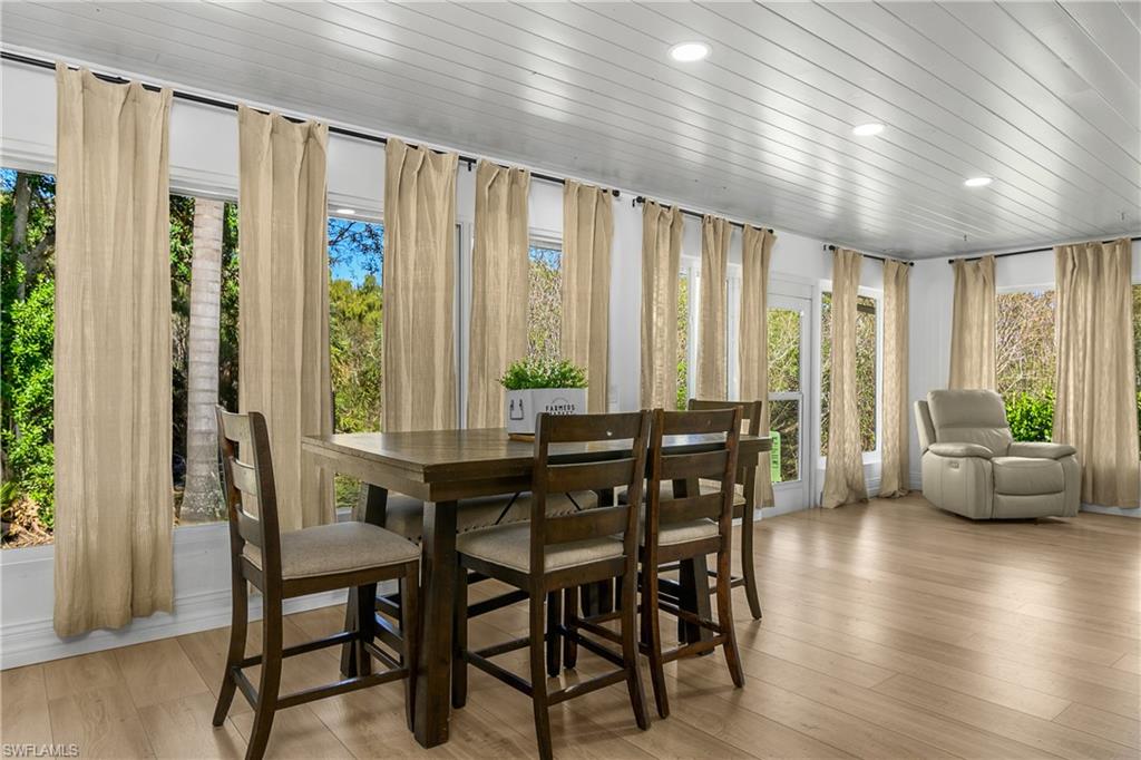401 Countryside Drive Naples, FL 34104 - Photo 15 of 30 a view of a dining room with furniture and window