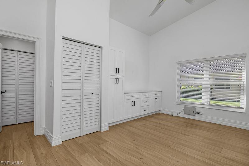 401 Countryside Drive Naples, FL 34104 - Photo 17 of 30 an empty room with wooden floor and windows