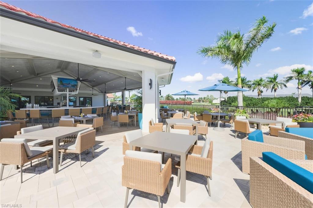 401 Countryside Drive Naples, FL 34104 - Photo 24 of 30 a view of a patio with a table and chairs potted plants