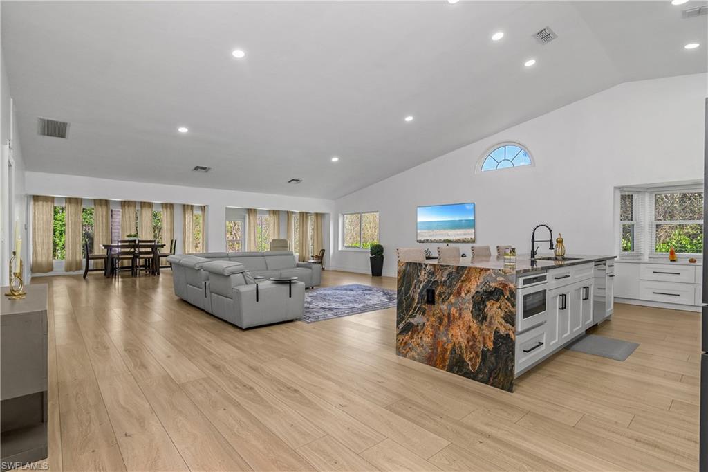 401 Countryside Drive Naples, FL 34104 - Photo 6 of 30 a living room with furniture and a wooden floor