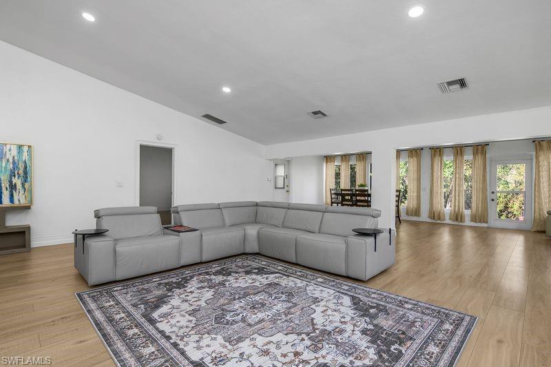 401 Countryside Drive Naples, FL 34104 - Photo 7 of 30 a living room with furniture and a rug