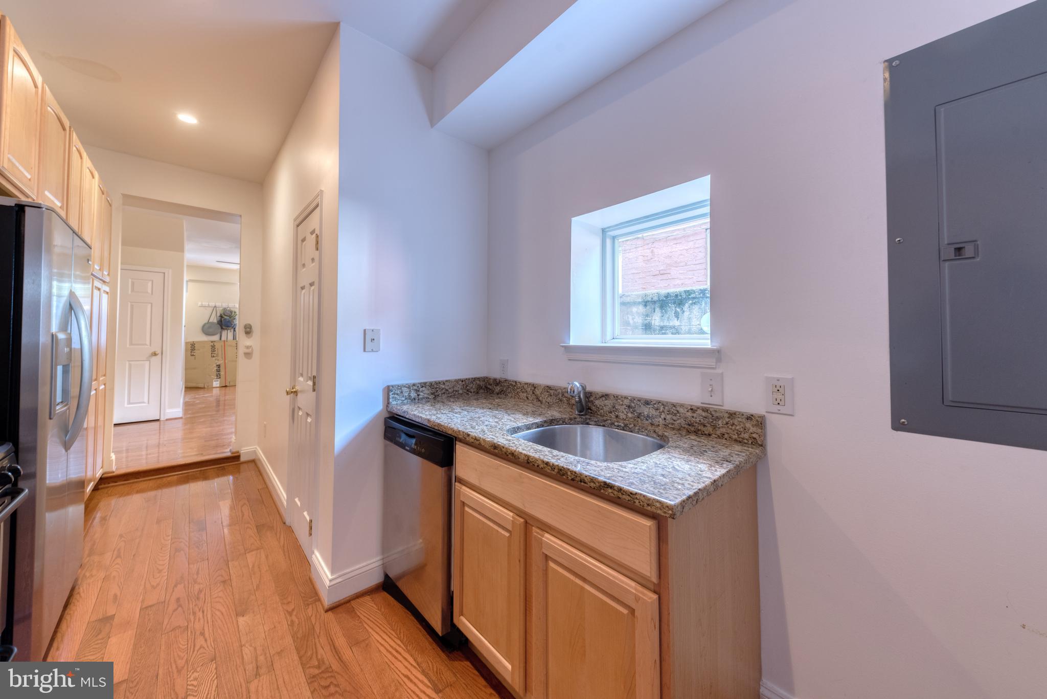 1818 Bank Street Baltimore, MD 21231 - Photo 8 of 20 a kitchen that has a sink and a wooden floor