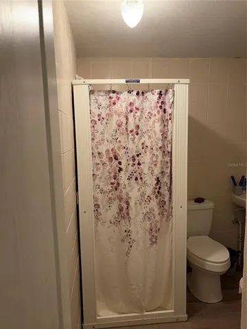 a bathroom with a toilet and shower