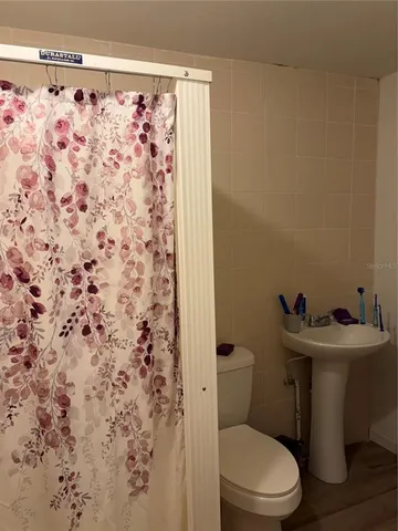 a white toilet sitting next to a sink